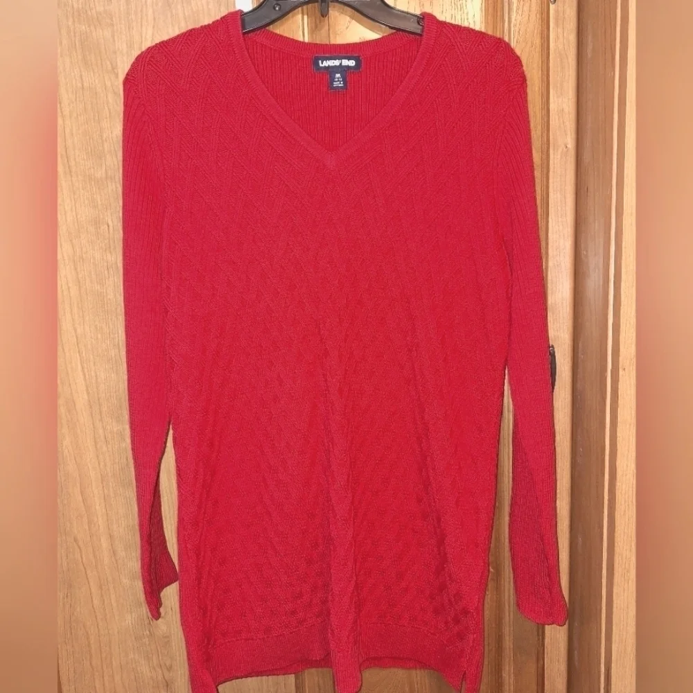 A Lands End cable knit sweater in a size medium 100% cotton.